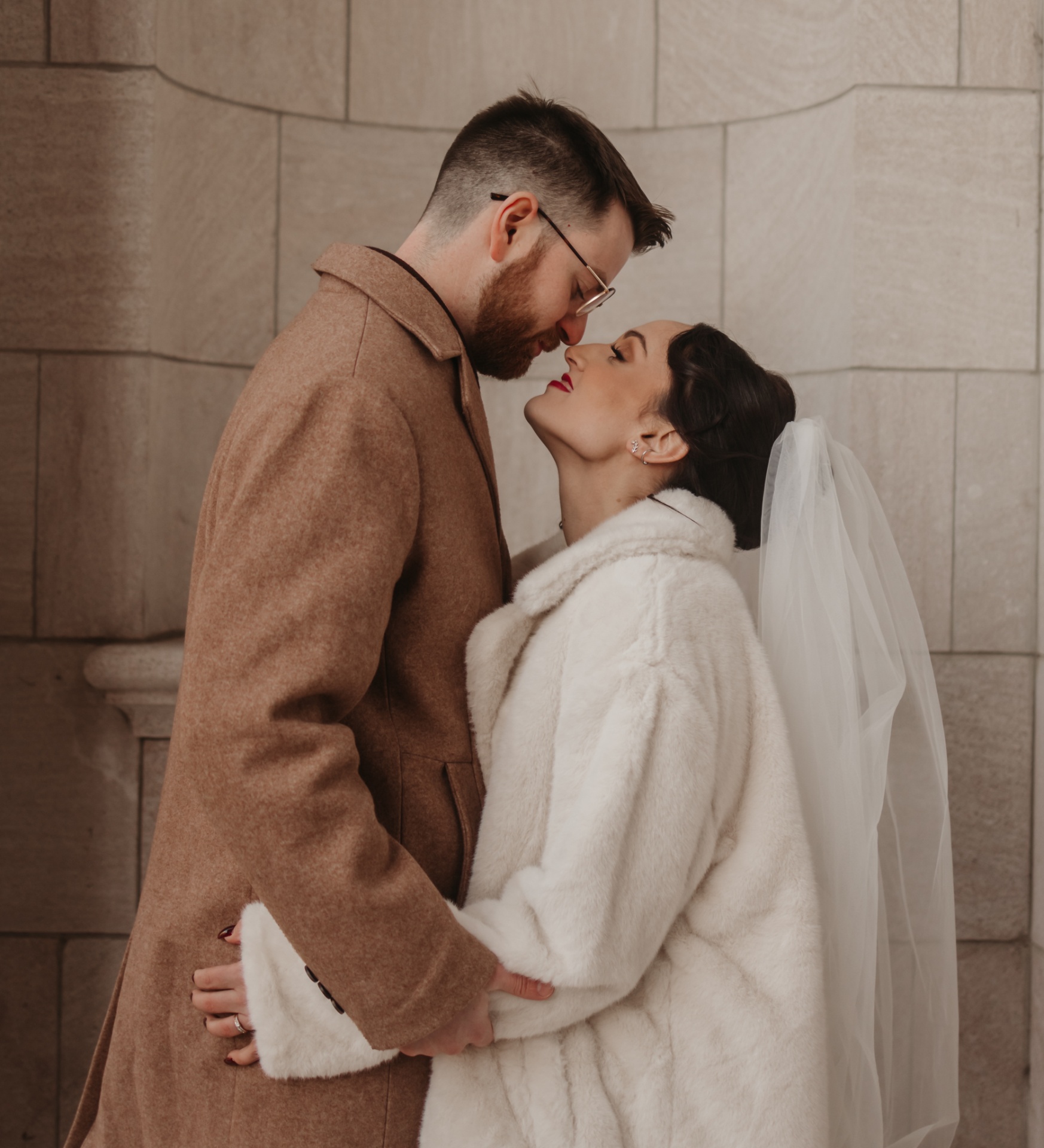 Bride and groom embracing in winter coats