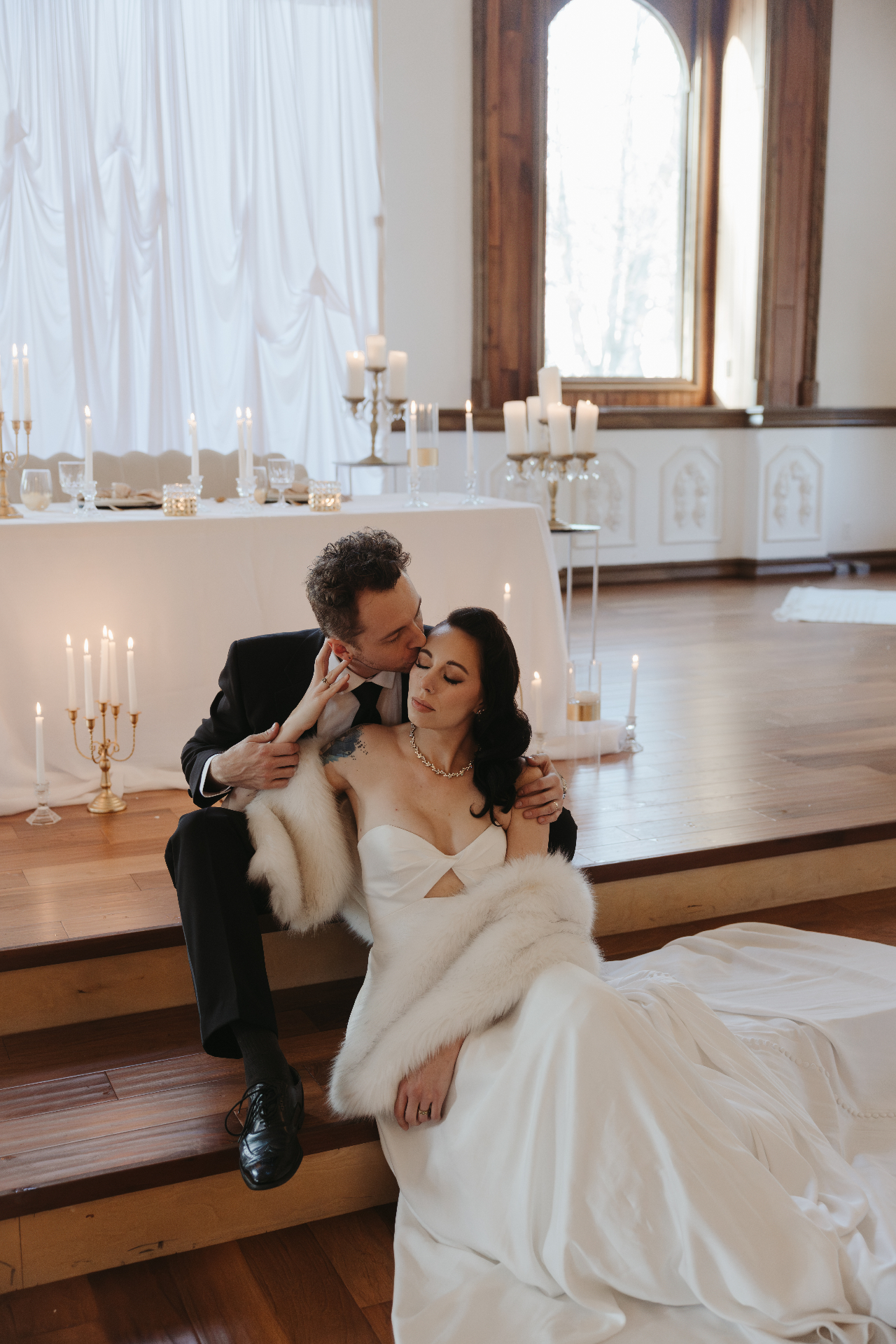 Bride and groom at candlelit reception hall
