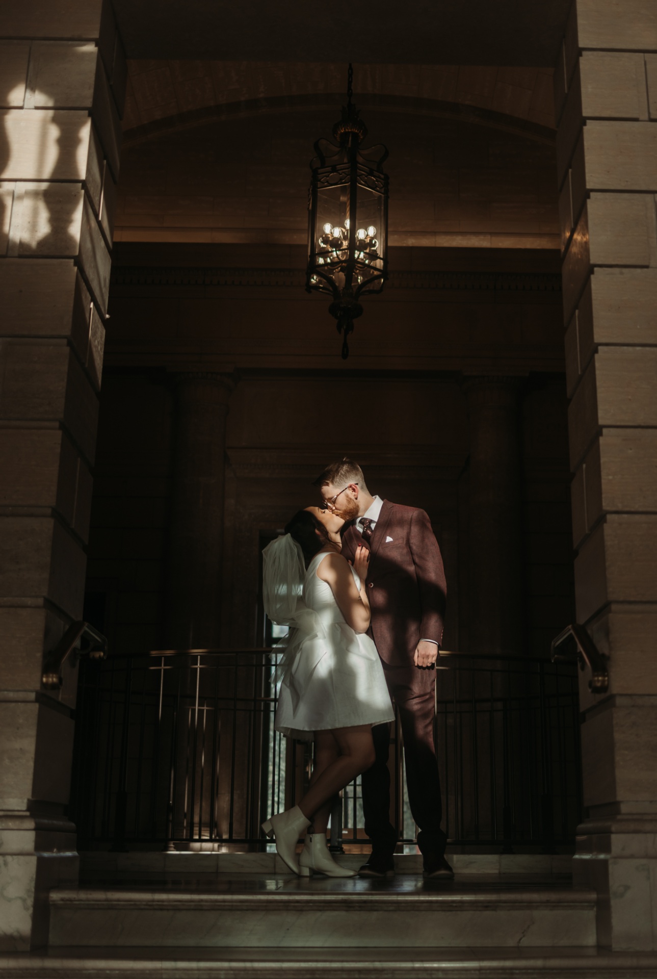 Couple kissing under lantern on balcony